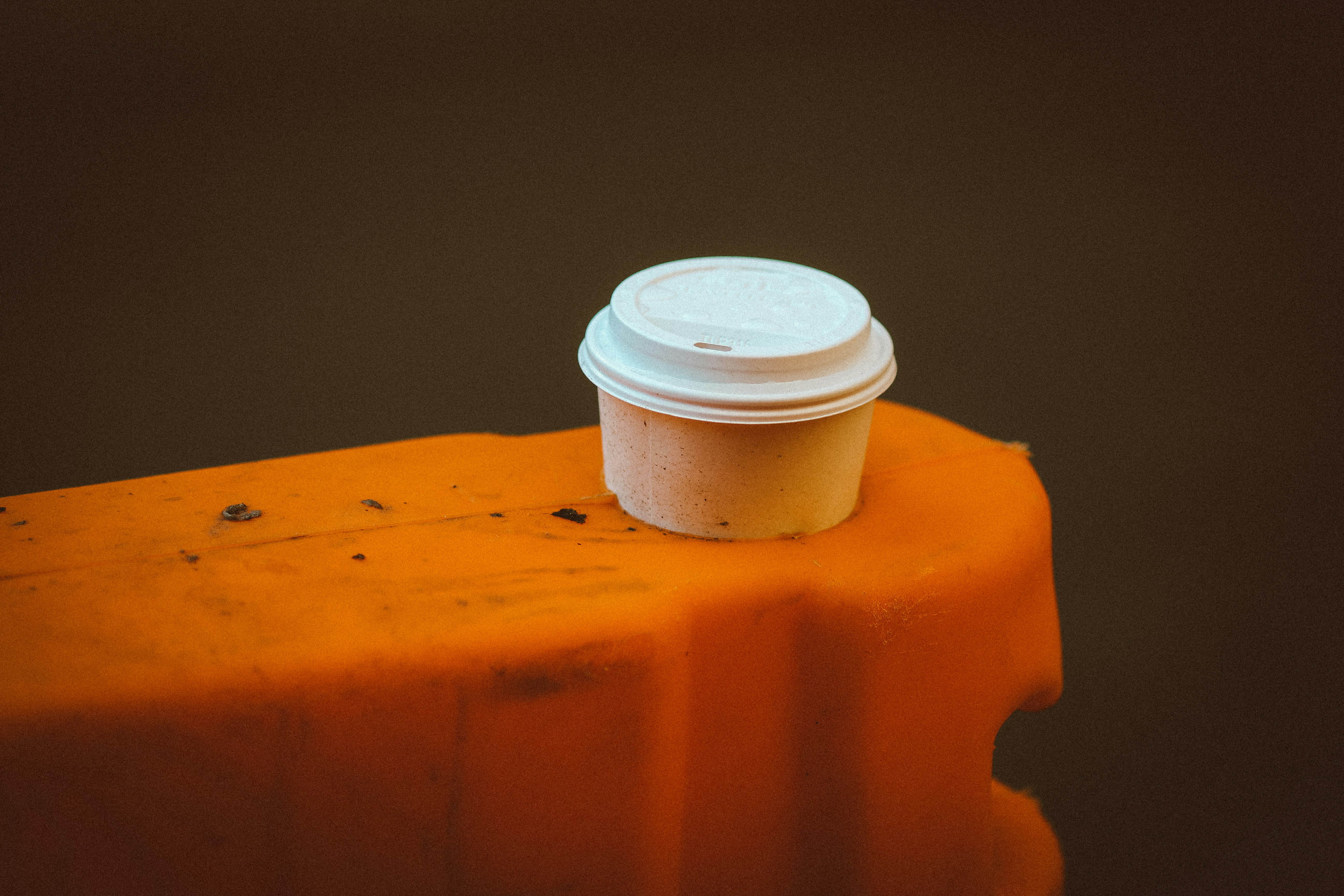 white plastic cup on yellow plastic table